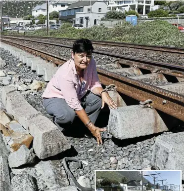  ?? Ruvan Boshoff Pictures: ?? DA ward councillor Felicity Purchase inspects a section of damaged railway track between St James and Kalk Bay.