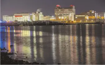  ?? STAFF FILE PHOTO BY NICOLAUS CZARNECKI ?? EDUCATIONA­L RESOURCE: The lights of UMass Boston reflect on the waters of Dorchester Bay. The school provides necessary support for the city’s residents.