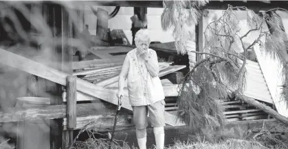  ?? CHRIS GRANGER/THE TIMES-PICAYUNE AND THE NEW ORLEANS ADVOCATE ?? Surveying the damage for the first time, Sharon Orlando tries to hold back tears on the morning after Hurricane Ida hit her Destrehan, Louisiana, home.