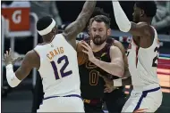  ?? TONY DEJAK — THE ASSOCIATED PRESS ?? Cavaliers Kevin Love ries to get past Suns’ Torrey Craig, and Deandre Ayton in the first half May 4in Cleveland.