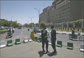  ?? AP/VAHID SALEMI ?? Police officers stand guard Thursday in front of Iran’s parliament building in Tehran.