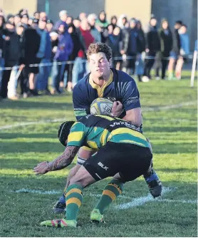  ?? PHOTO: GREGOR RICHARDSON ?? Going through . . . Dunedin No 8 Jamie Mowat tries to bump off the tackle of Green Island midfield back Sam Eriepa at Kettle Park on Saturday.