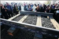  ?? LUIS SINCO/LOS ANGELES TIMES ?? Invited guests sign segments of railroad track during a groundbrea­king ceremony for a bullet train station Tuesday, Jan. 6, 2015 in Fresno. The train could cost taxpayers 50 percent more than estimated.