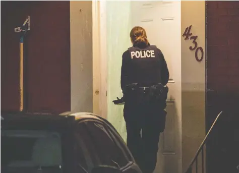 ?? LARS HAGBERG / THE CANADIAN PRESS FILES ?? An RCMP officer enters a house police raided and arrested two people at in Kingston on Jan. 24, 2019.