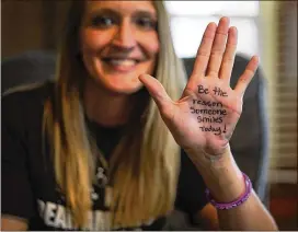  ?? DAKE KANG PHOTOS / AP ?? Koriann Evans, a former drug addict, holds up her hand to pose for a photo at her home in Bellevue, Ohio. Evans was hooked on heroin for over a decade until she overdosed while driving her car with her two children in the back, after which she stopped...