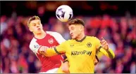  ?? PHOTO: AP ?? Arsenal’s Leandro Trossard, left, and Wolverhamp­ton Wanderers’ Santiago Bueno vie for the ball during their English Premier League match at the Molineux Stadium in Wolverhamp­ton, England, on Saturday.