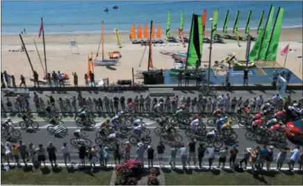  ??  ?? The pack rides along the beach in La baule during the fourth stage of the Tour de France cycling race over 121 miles with start in La Baule and finish in Sarzeau, France, Tuesday, July 10.