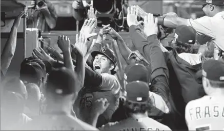  ?? Robert Gauthier Los Angeles Times ?? THE ROYALS’ HERO DU JOUR, Eric Hosmer, ismobbed in the dugout after his two- run homer broke a 1- 1 tie in the 11th inning.