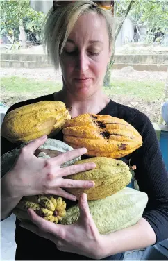  ??  ?? Chrystal Porter, chocolatie­r for Toronto-based ChocoSol, carries harvested cacao pods.