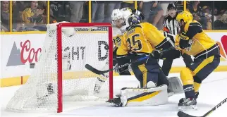  ?? FREDERICK BREEDON/GETTY IMAGES ?? Penguins forward Patric Hornqvist scores the winning goal against Predators goaltender Pekka Rinne late in the third period. Carl Hagelin added an empty-netter with seconds remaining.