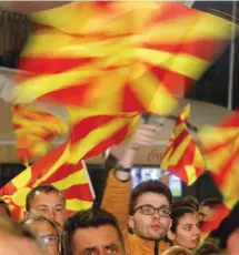  ?? ?? Opposition VMRO-DPMNE supporters wave flags during an electoral gathering in Shtip, North Macedonia, on Monday.