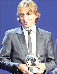  ?? — AFP photo ?? Modric receives the UEFA player of the season award during the draw for UEFA Champions League at The Grimaldi Forum in Monaco.