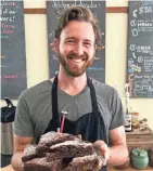  ?? KLETT JENNIFER RUDE ?? Large Batch Scratch co-owner Patrick Michaels serves up bourbon brownies at The Kitchen at Arcadia Books in downtown Spring Green.