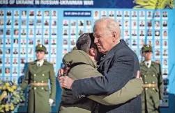  ?? UKRAINIAN PRESIDENTI­AL PRESS OFFICE VIA AP ?? Biden, right, embraces Zelenskyy at a memorial wall for fallen soldiers in Kyiv on Monday.