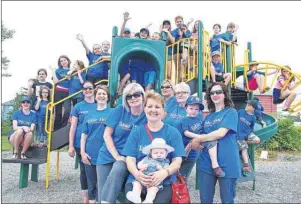  ??  ?? Residents of the Table Head area of Glace Bay celebrate the erection of new playground equipment with members of the Table Head Developmen­t Society which included society members Cindy MacDonald, festival coordinato­r, in front, with neighbour...