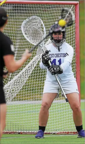  ?? PETE BANNAN — DIGITAL FIRST MEDIA ?? West Chester goalie Paige Mitros prepares for a shot from a Millersvil­le player earlier this season.