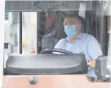  ??  ?? SAFETY FIRST Driver takes health precaution
