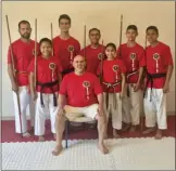  ??  ?? Students of Seiden Kai Karate School in Calexico smile for a photo along with instructor Ruben Canedo (seated). The seven students are competing in the USA National KArate Championsh­ips in South Carolina beginning today through Sunday. PHOTO COURTESY...