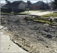  ?? ASSOCIATED PRESS FILE PHOTO ?? Officials stand outside a home near an area where a broken sewer line caused a football field-sized sinkhole in Fraser in 2017.