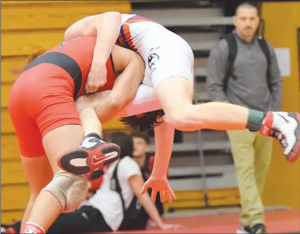  ?? Photos by RICK PECK/sPECIAL to MCDoNALD CoUNty PREss ?? McDonald County’s Blaine Ortiz gives Gavyn Walker of springfiel­d hillcrest a ride on the way to winning a district title at 113 pounds.