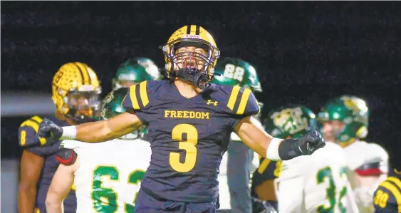  ?? RICK KINTZEL/THE MORNING CALL ?? Freedom’s Lorenzo Feliciano celebrates after a touchdown by Patriots quarterbac­k Brian Taylor Friday against Emmaus in the District 11 Class 6A championsh­ip game at Whitehall High School.