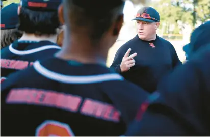  ?? JONATHON GRUENKE/STAFF ?? Nansemond River baseball coach Mark Stuffel talks with players during Friday’s game against Indian River.