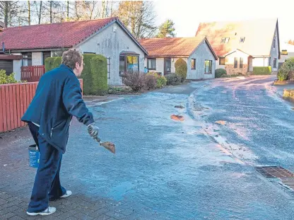  ??  ?? Glenrothes residents gritting their pavements to remove ice from paths due to a lack of resources.