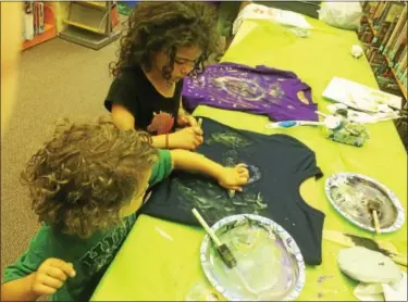  ?? EVAN BRANDT — DIGITAL FIRST MEDIA ?? Blue Bell residents Vincenzo Yaghooty, 3, and his sister Serafina, 5, work on their Galaxy shirts during a program Friday at the Pottstown Regional Public Library.