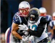  ?? KEVIN C. COX / GETTY IMAGES ?? Rob Gronkowski, who left Sunday’s game after a helmetto-helmet hit against Barry Church, “was in pretty good spirits” Monday, a teammate said.