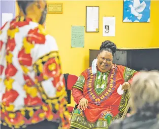  ?? JUAN ANTONIO LABRECHE/FOR THE NEW MEXICAN ?? Tonya Covington, a community health worker and mediator in Albuquerqu­e, takes part Saturday in the Albuquerqu­e Center for Peace and Justice’s Kwanzaa opening ceremony.