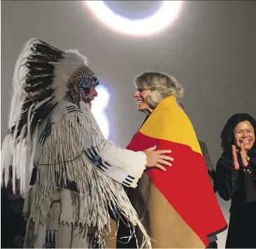  ??  ?? President Elizabeth Cannon and Dr. Reg Crowshoe embrace during the official launch and celebratio­n of the University of Calgary’s Indigenous Strategy.