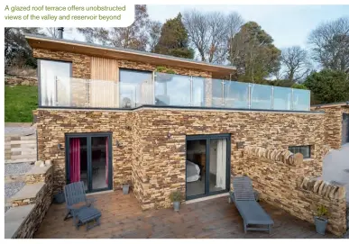  ??  ?? A glazed roof terrace offers unobstruct­ed views of the valley and reservoir beyond