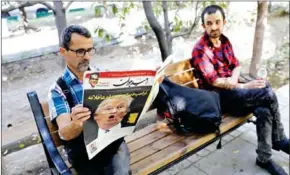  ?? STRINGER/AFP ?? An Iranian man reads a copy of the daily newspaper bearing a picture of US President Donald Trump with a headline that reads in Persian ‘Crazy Trump and logical JCPOA [Joint Comprehens­ive Plan of Action]’, on Saturday, in Tehran.