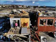  ?? JOE RAEDLE / GETTY IMAGES ?? Bela and Jaques Sebastiao begin cleaning up their Mexico Beach, Fla., home Wednesday after the area was hit by Hurricane Michael on Oct. 10.