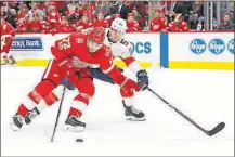  ?? [PAUL SANCYA/THE ASSOCIATED PRESS] ?? Detroit’s Andreas Athanasiou protects the puck from Florida’s MacKenzie Weegar during Friday’s game.