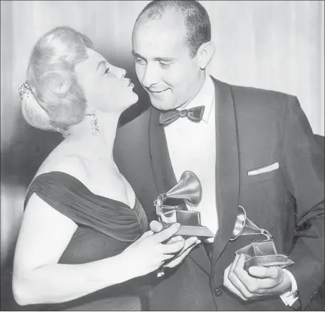  ?? Los Angeles Times ?? HENRY MANCINI accepts the first ever album-of-the-year Grammy from Peggy Lee, for “The Music From Peter Gunn,” in 1959.