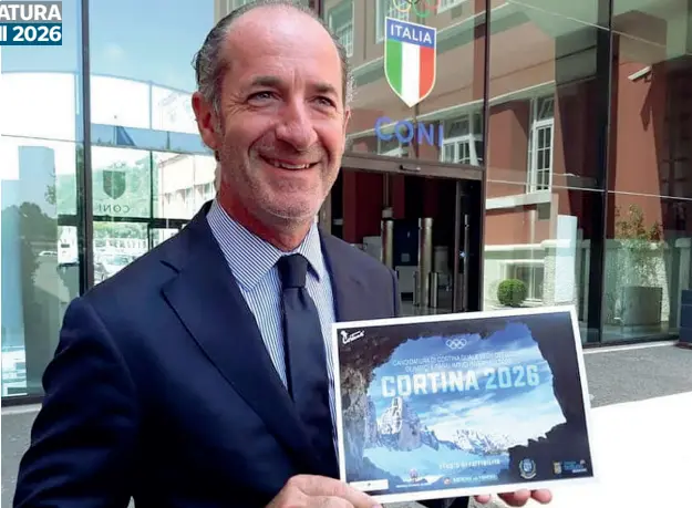  ??  ?? Davanti alla sede del Coni Uno Zaia fiducioso e sorridente mostrava la cartolina olimpica delle Dolomiti. Nonostante le sorprese non ha perso l’ottimismo