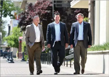  ??  ?? RECORDER PHOTO BY CHIEKO HARA Michael Knopf, principal engineer/principal surveyor-special project, left, Ron Wathen, QK president, and Jeff Cowart, QK vice president of Quality Control and Municipal Services, right, walk together April 26, in downtown...