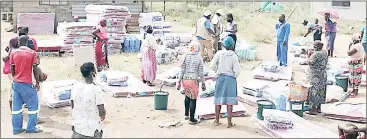  ?? (File pic) ?? Community members receiving blankets and mattresses from the NDMA team. The auditor general was critical of the agency’s accounting system.