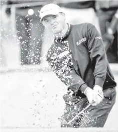  ??  ?? Paul Lawrie of Scotland hits out of the bunker onto the 13th green during the first round of the European Masters golf tournament in the Swiss mountain resort of Crans-Montana in this Aug 30, 2012 file photo. — Reuters photo