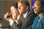  ?? Steve Helber / Associated Press ?? Consumer Financial Protection Bureau Director Richard Cordray, center, listens to comments during a panel discussion in Richmond, Va., last year.