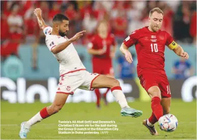  ?? (AFP) ?? Tunisia’s Ali Abdi (left) and Denmark’s Christian Eriksen vie for the ball during the Group D match at the Education City Stadium In Doha yesterday.