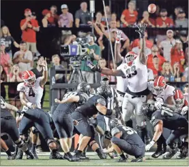  ?? aP-mark humphrey ?? Georgia defensive lineman Jordan Davis (99) reaches for a 26-yard field goal by Vanderbilt kicker Ryley Guay (98) in the first half on Saturday in Nashville, Tenn.,