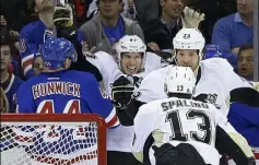  ?? Frank Franklin II/Associated Press ?? Sidney Crosby celebrates with teammates Nick Spaling (13) and Steve Downie after Spaling tied the score with a goal in the second period Friday. The Rangers won again, 2-1, and eliminated the Penguins from the playoffs.