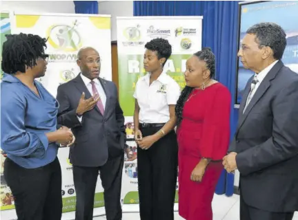  ?? (Photo: JIS) ?? Minister of Industry, Investment and Commerce Senator Aubyn Hill (second left) speaks with (from left) consultant, Pricesmart Foundation, Dr Bridgette Barrett; founder/executive director, Young Women of Purpose/young Men of Purpose, Lanisia Rhoden; technical specialist, socio-economic eevelopmen­t, Planning Institute of Jamaica (PIOJ), Charmaine Brimm; and deputy director general, corporate governance and management, PIOJ, Kirk Phillips. The occasion was Monday’s launch of the Realise, Embrace, Achieve Your Purpose (REAP) Women Entreprene­urship Project 2024 at the PIOJ in New Kingston.