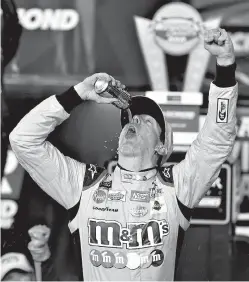  ?? AP Photo/Steve Helber ?? ■ Kyle Busch celebrates in Victory Lane after winning the NASCAR Cup Series auto race Saturday at Richmond Raceway in Richmond, Va.
