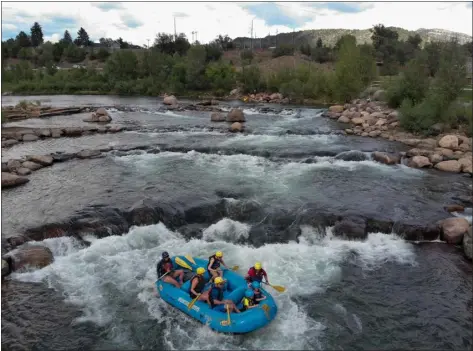  ?? PHOTOS BY JOSH STEPHENSON / SPECIAL TO THE DENVER POST ?? A raft carrying members of the Hartford family, who were visiting Durango, goes down the Animas River with Mountain Waters Rafting on July, 14. Water levels have been dropping in rivers across the state, including the Animas, threatenin­g the rafting industry.