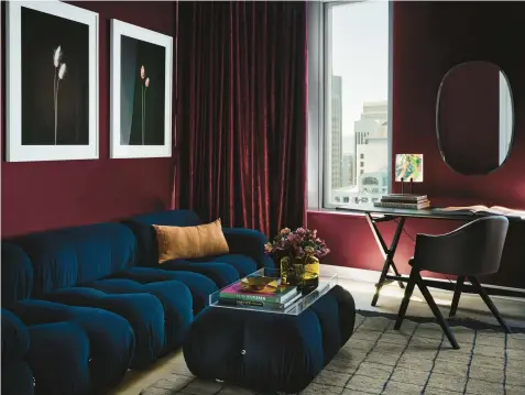  ?? FRENCHCALI­FORNIA ?? This stylish living room is painted in Backdrop’s Lobby Scene, a dark, warm purple-red inspired by the film “The Grand Budapest Hotel.”