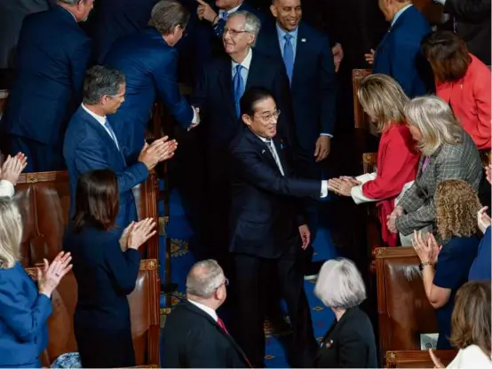  ?? JOSE LUIS MAGANA/ASSOCIATED PRESS ?? Japan’s Prime Minister Fumio Kishida shook hands with members of Congress as he arrived to addresses a joint meeting of Congress in the House chamber on Thursday.