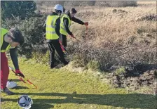  ?? Photograph­s: Mid Argyll Youth Developmen­t Services. ?? The youngsters have been learning about the maintenanc­e of the greens and equipment used for the upkeep, and helping to tidy overhangin­g branches, seeding and repairing divots.